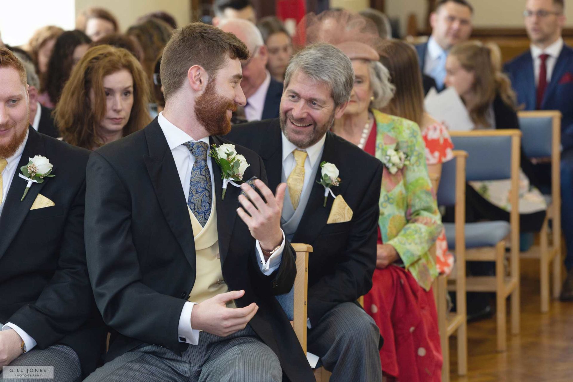 a father and groom are exchanging words at this north wales wedding