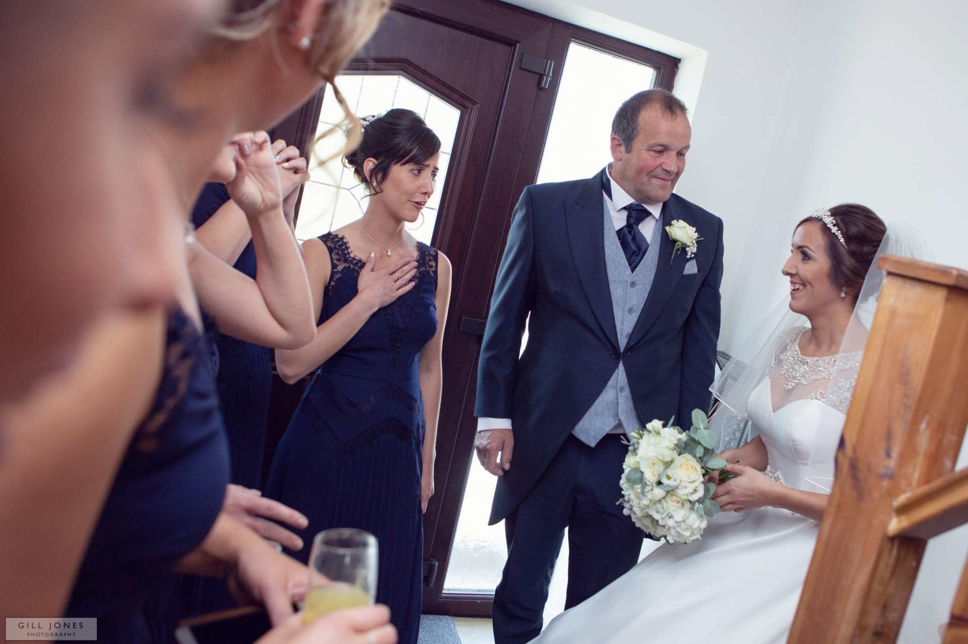 the bride appears to her father and bridesmaids