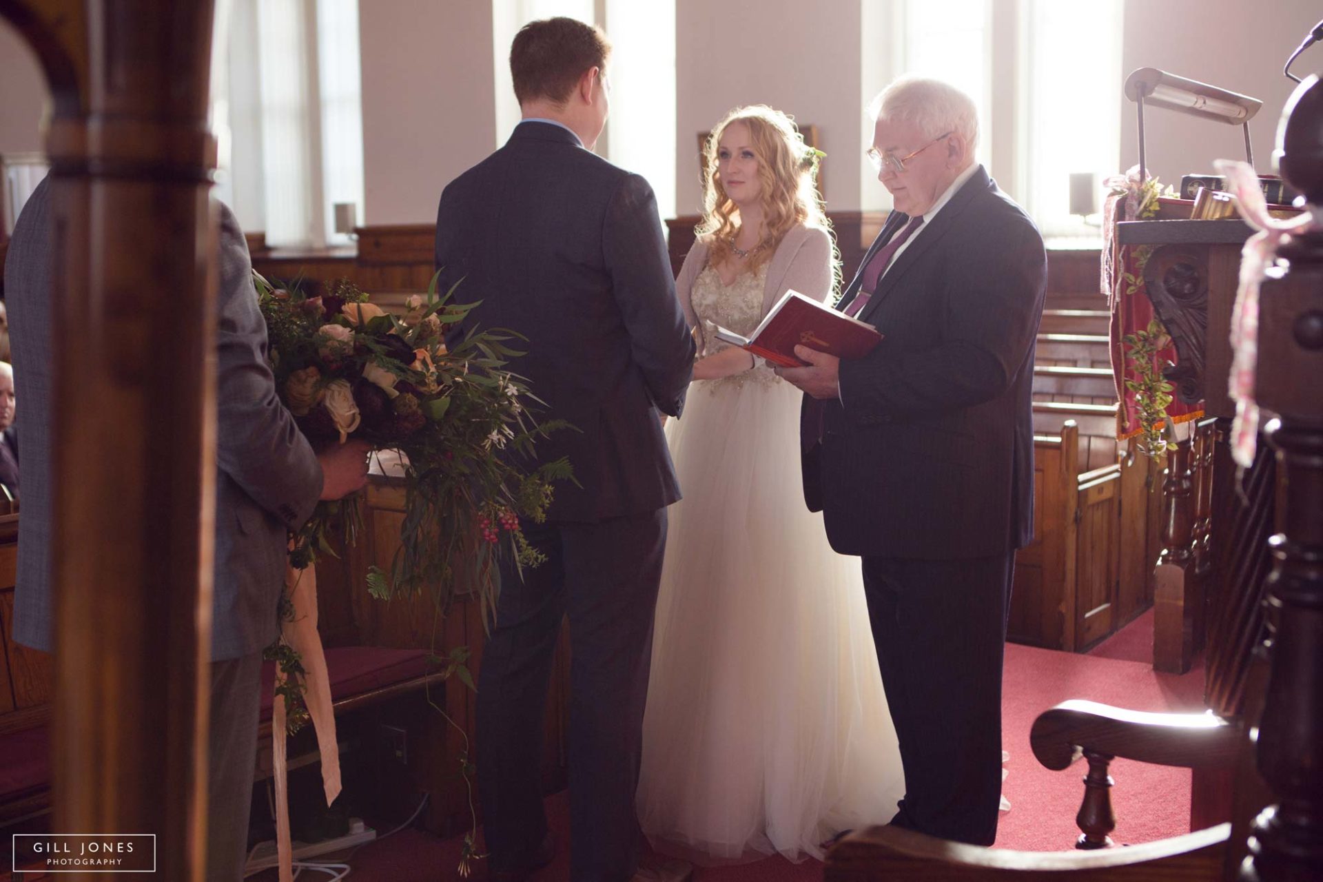 the bride and groom exchanging their vows