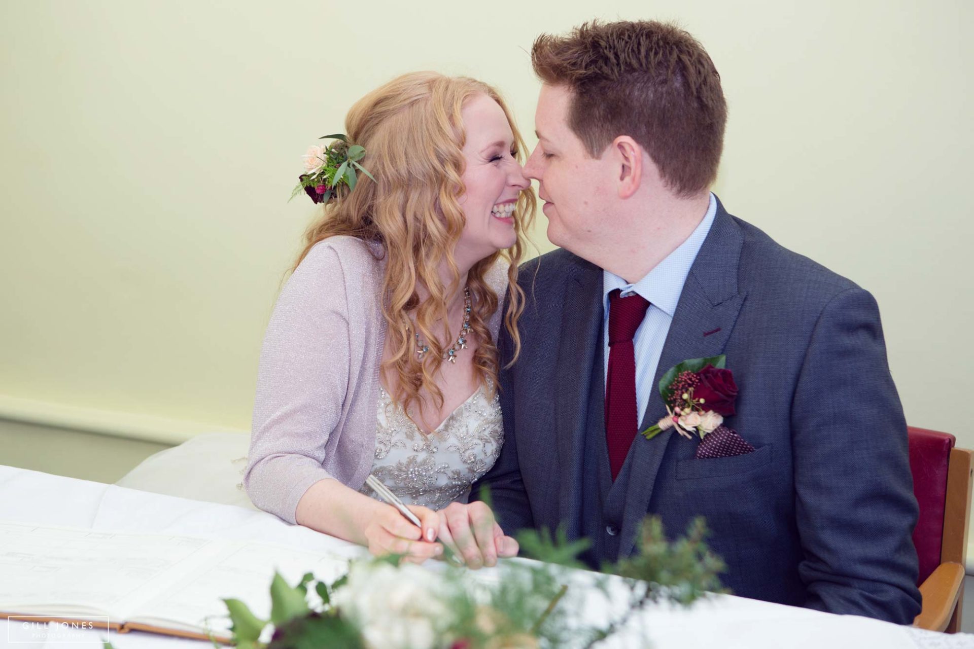 bride and groom smiling after signing the register