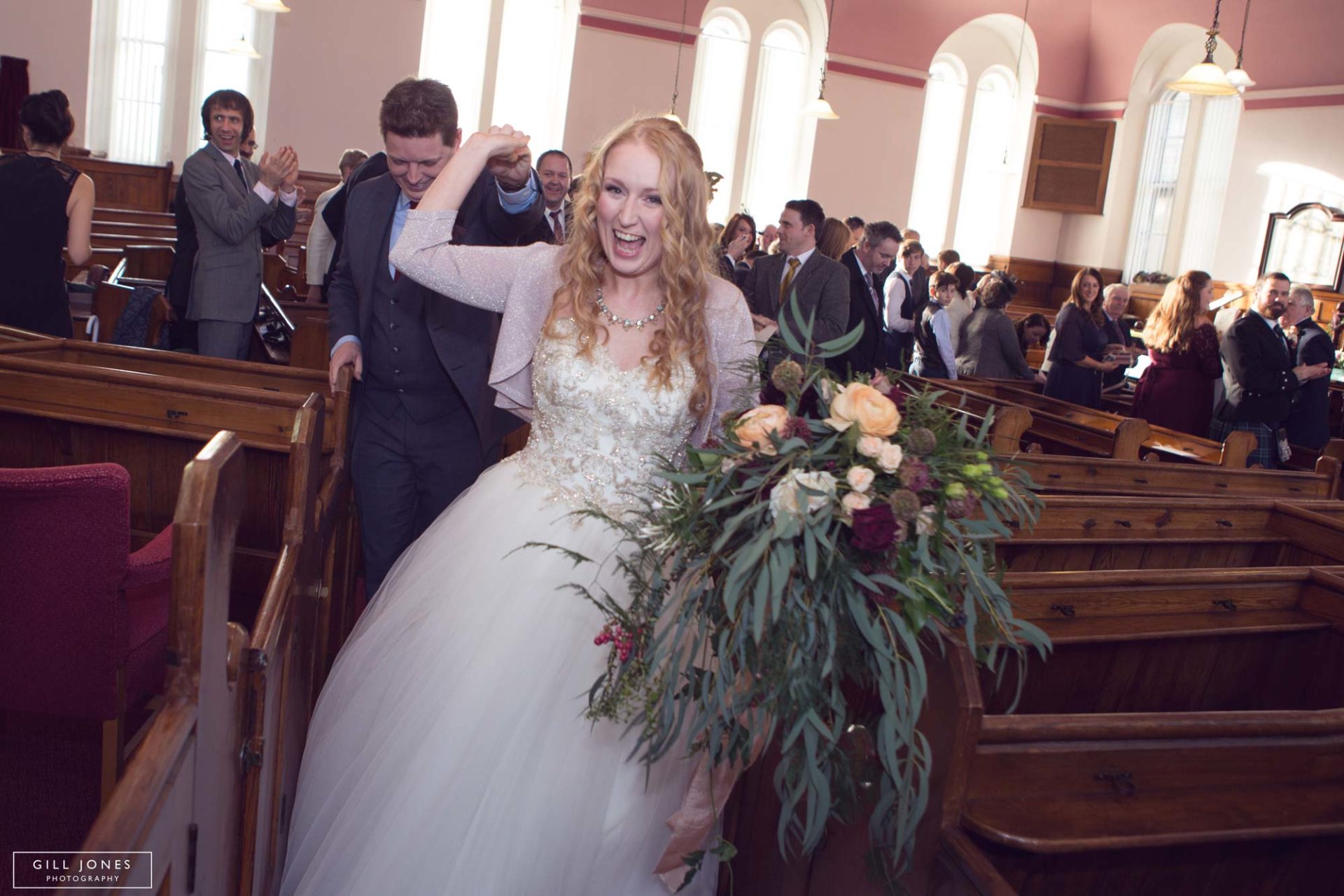 the bride leading the groom out of chapel