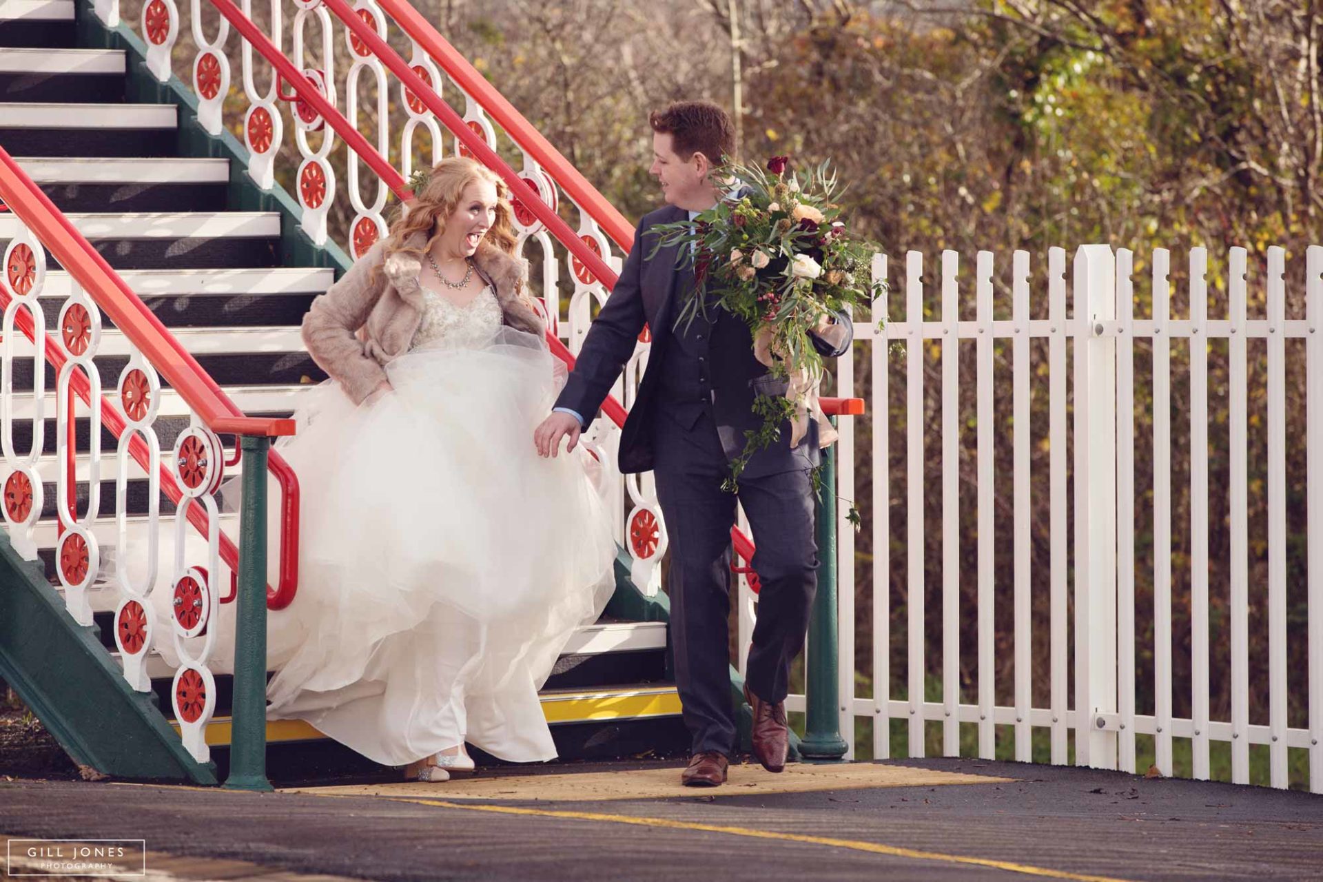 bride and groom hurrying along a train station platform