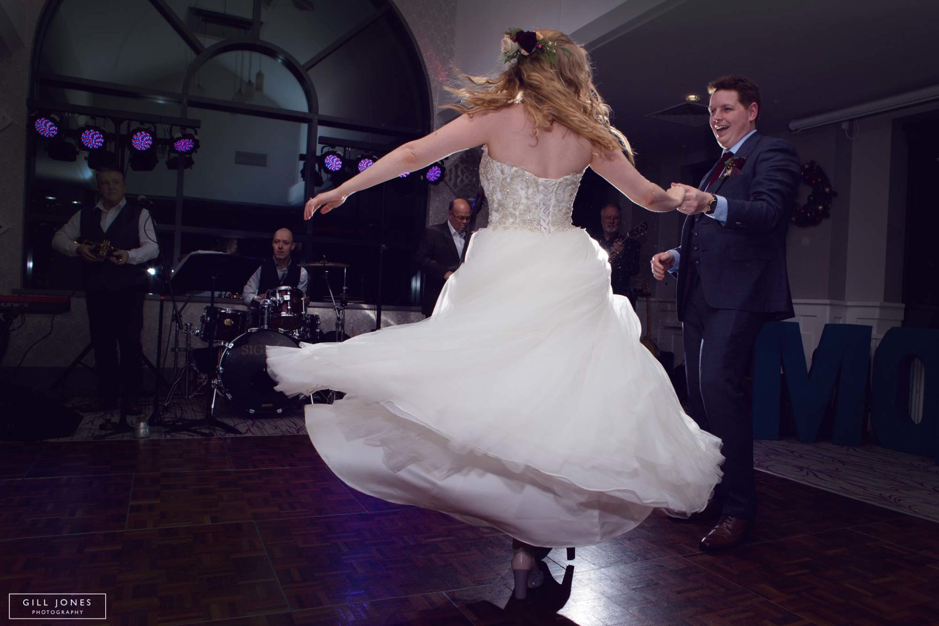 the bride twirling in her dress on the dancefloor