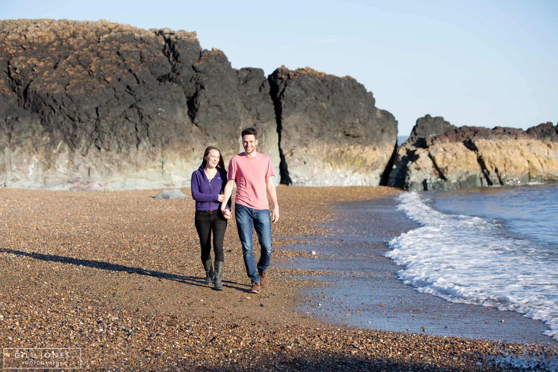 a couple walking along the shoreline