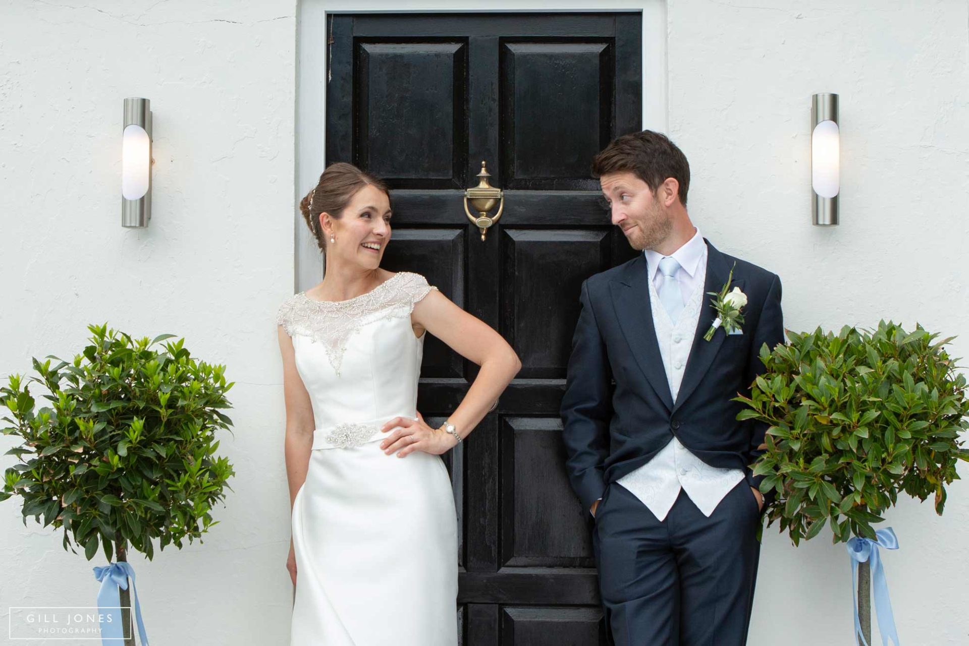 bride and groom by the front door of their home