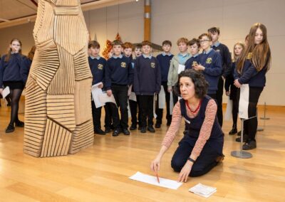 a group leader instructs a group of children on a mindful exercise Anglesey commercial photographer Gill Jones photography