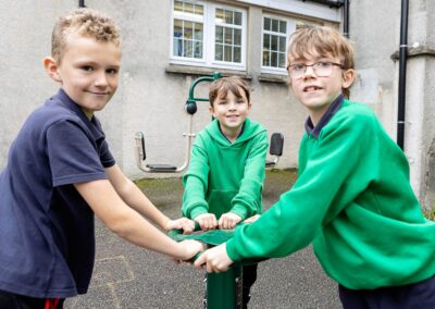 three boys play on a pice of playground apparatus by Anglesey commercial photographer Gill Jones photography