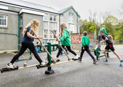 a group of school children play on their new apparatus by Anglesey commercial photographer Gill Jones photography