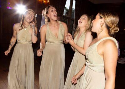 four bridesmaids sing with enthusiasm