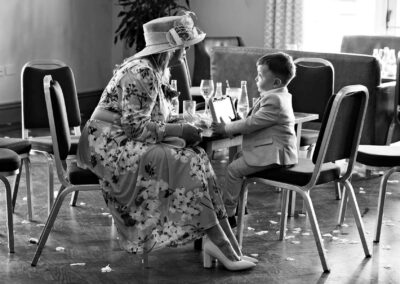 a grandmother chats with her young grandson, his eyes look up to her gaze